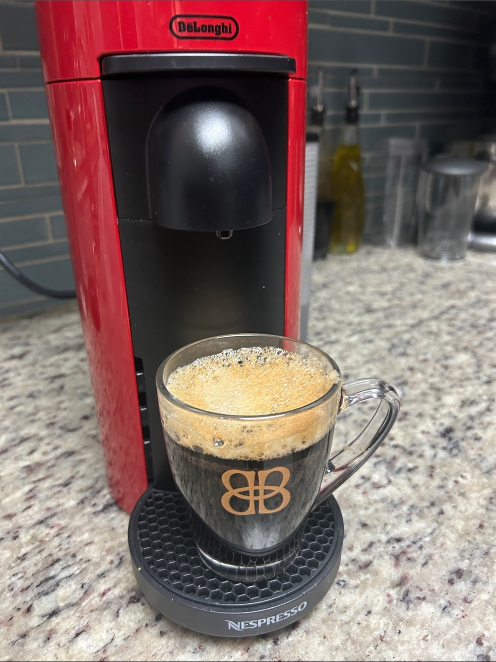 Nespresso Red Espresso Machine with Black Accents and Gold Logo Cup